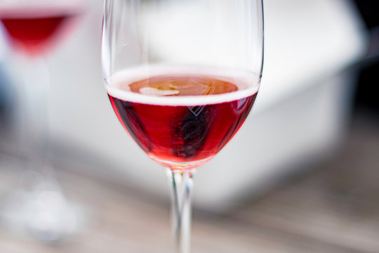 A close up of sparkling Ros&eacute; wine glass on a picnic table