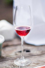 A close up of sparkling Rosé wine glass on a picnic table
