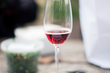 A close up of sparkling Rosé wine glass on a picnic table