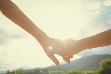 Brother and sister hold hands.Happy in making merit. Mother's love in the hand, on the palm
