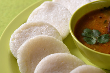 Idli with Sambar in bowl on green background, Indian Dish : south Indian favourite food rava idli...