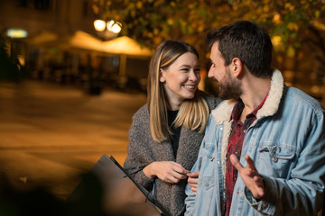 Fototapeta premium Young couple outside with shopping bags