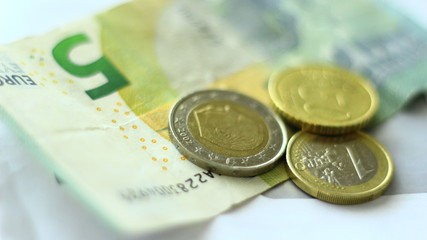 Euro coins and Euro paper money.