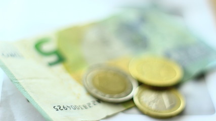 Euro coins and Euro paper money.