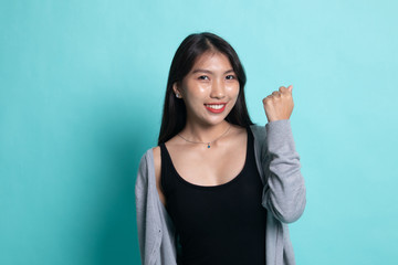 Fototapeta premium Successful young Asian woman hold fist up.
