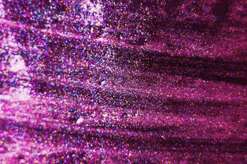 Gold and pink glitter on a black background as a background. Abstract christmas background with festive lights and copy space - magic bokeh sparkle. unfocused, focused