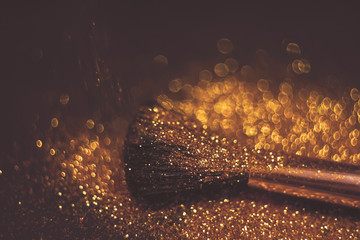 texture of gold glitter on the makeup brush and design. Selective Focus