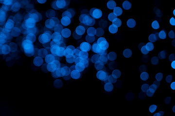 Defocused of blurred blue bokeh circle light from lighting bulb in the night for abstract background texture patterns