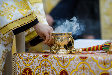 Details with a golden metallic christian orthodox frankincense burner, or censer. - obrazy, fototapety, plakaty