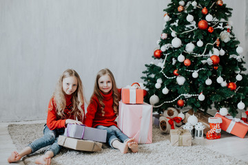 two blonde girlfriends sisters girls Christmas presents new year tree