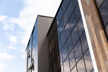 Tall modern business center building with glass office building