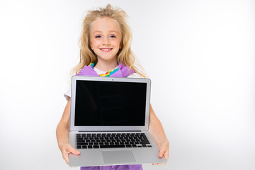 blond child in a casual look shows a laptop display with a mockup on a white background