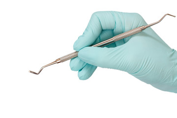 Dentist's hand with probe on white background.