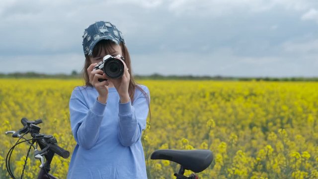 A child with a camera in the field.