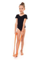 Fototapeta premium young gymnast child doing stretching with elastic tape on a white background