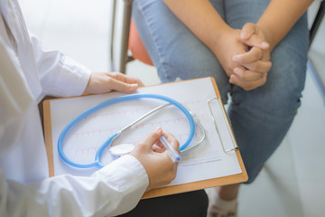 Woman Patient having consultation with doctor or psychiatrist who working on diagnostic examination on women's health disease or mental illness in medical clinic or hospital mental health service