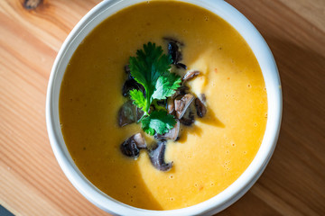 Homemade Thai Sweet Potato Soup with Cilantro, Coconut Milk Cream, Lime and Mushrooms.