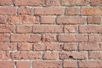 Old brick wall of bricks of different sizes as a background