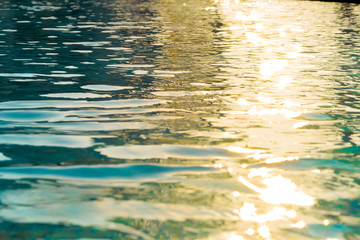 Fototapeta na wymiar water background pure water surface navy dark blue color scenery soft focus of swimming pool