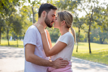Obraz premium Couples standing kiss and hugging in the park.