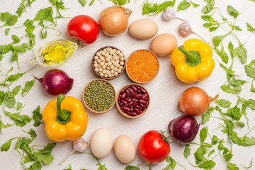 A set of vegetables for a healthy diet, yellow and red peppers, lentils and beans, chickpeas,  tomatoes, onions, garlic. .