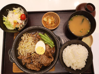 Japanese food set is placed in box on the table, Stir-fried Beef with Oyster Sauce, Rice, Salad, Kimchi, Soup. 