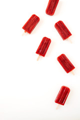 Red ice-creams on white background. Flat lay, top view.