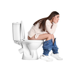 Upset woman sitting on toilet bowl, white background