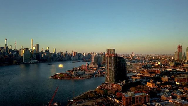 Epic Motionlapse (timelapse) of NYC panning from Brooklyn over East River to Manhattan Skyline. Empire State, chrysler building, United Nations, Sunrise to sunset, with clouds and boats.
