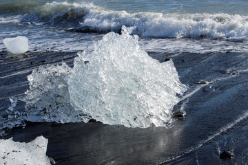 large pieces of iceberg on black sand beach in Iceland