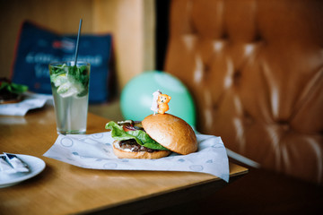 the first children's hamburger for a birthday with a candle