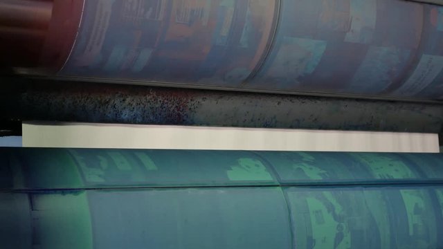 Installing new printing plates at the ink rollers of press machine