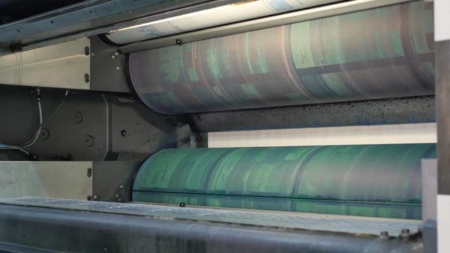 Installing new printing plates at the ink rollers of press machine