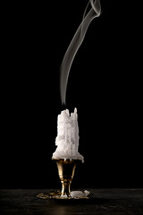 smoke over an extinguished candle with smudges of wax