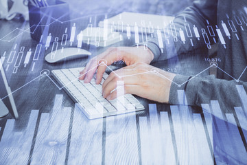 Fototapeta premium Multi exposure of financial graph with man works in office on background. Concept of analysis.