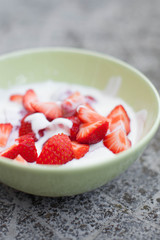 fresh strawberries in a bowl of yoghurt