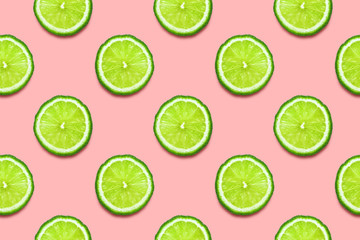 Lime slices seamless pattern on pastel pink background. Minimal summer concept. Flat lay, trendy juicy color.