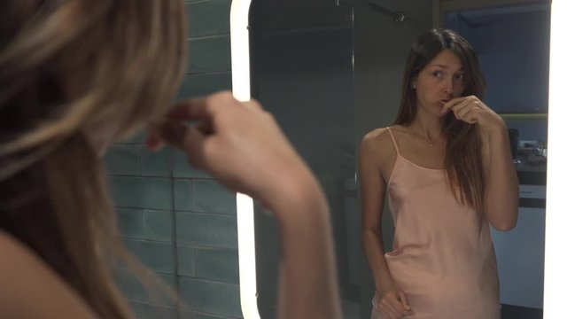 Pretty Girl Brushing her Tooth With Eco Natural Wooden Bamboo Toothbrush. Young Sexy Woman Morning Routing. Dental Care Plastic Free and Zero Waste Concept. 4K Footage
