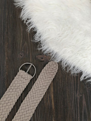 Gray wicker belt on wooden background