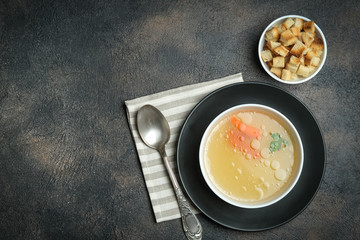 Hearty lunch. Meat broth or bouillon  from veal with breadcrumbs on a dark background. Top view. Copy space.