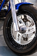 Closeup view Brake disk, wheel and tyre of a motorcycle. Chrome wheel motorbike.