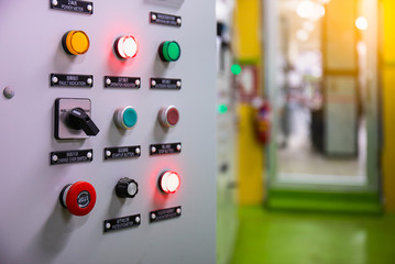 Electrical selector switch,button switch,Electrical switch gear at Low Voltage motor control center cabinet in coal power plant. blurred for background.