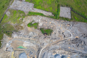 Aerial view of a small plant for the production and cleaning rubble and cement near the heaps of building materials, the tractors and trucks transports the finished product. Mining in quarry.