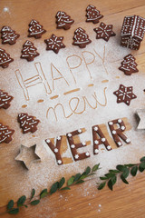 New Year's Eve background. Homemade chocolate cookies in shape of  Happy new year on a wooden table 
