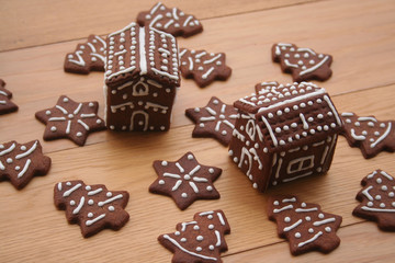 Christmas background. Homemade Christmas chocolate cookies in shape of little houses and trees on a wooden table