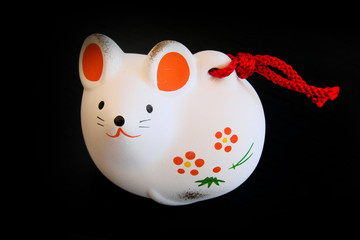 Cute ceramic japanese rat ornament on black background. 2020 year of the rat decor