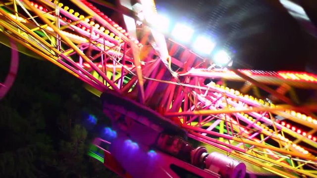Vivid lights of  carousel at night, operating, rotating.