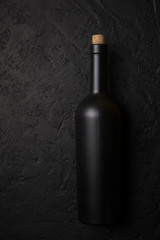 Red wine glasses and bottle on stone background. Top view with copy space