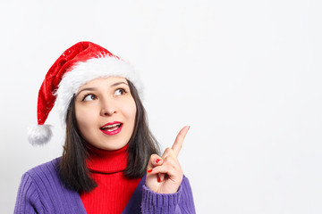 portrait of a sweet dreamy young woman in a red sweater and Christmas hat