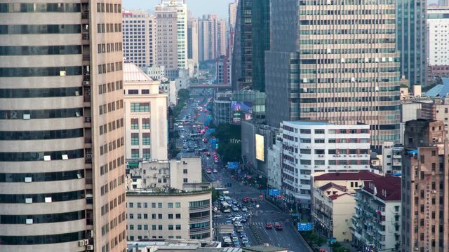 Traffic on Chinese street past Shanghai buildings timelapse pan up